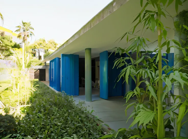 there is a building with blue doors and a green plant, inspired by João Artur da Silva, pavilion, sao paulo, archdaily, exterior, oscar niemeyer, the photo shows a large, with vegetation, by Xavier Blum Pinto, outside view, inter dimensional villa, by Ramó...