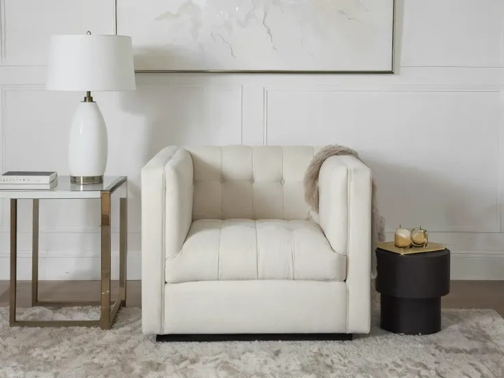 arafed chair and side table in a white room with a painting, tufted softly, cozy arm chairs, plush furnishings, armchairs, placed in a living room, luxury furniture, elegant furniture, cream and white color scheme, high resolution product photo, in a comfo...