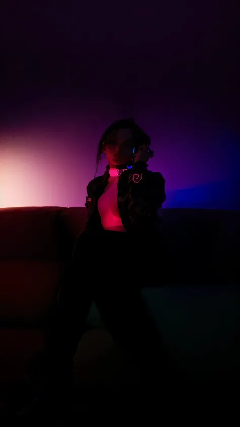 araffe sitting on a couch in a dark room with a purple light, with neon lights, glowing with colored light, neon lights in the background, extremely moody lighting, cyberpunk with neon lighting, soft neon atmosphere, dramatic gradient lighting, at night wi...