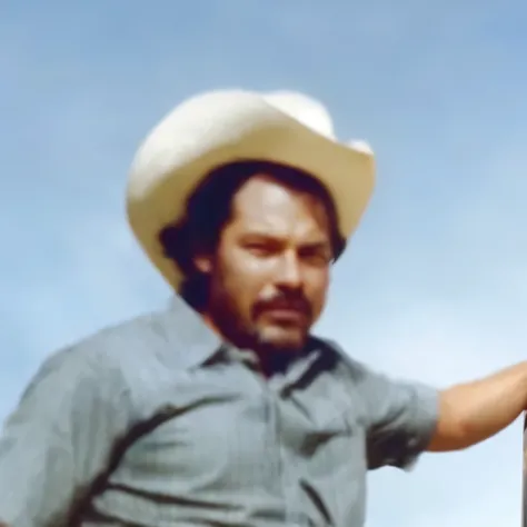 There is a man in a cowboy hat leaning against a pole, 