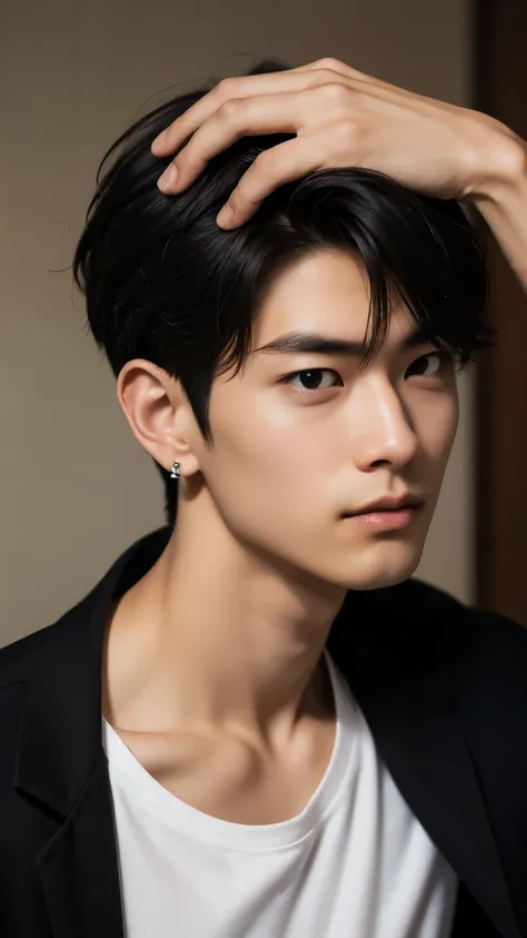 A young Japanese man in his early twenties. He has short, spiky black hair, with another young man's hand pushing his bangs back. He has sharp facial features and piercing eyes. His nose is straight and his mouth is firm, but he looks slightly embarrassed....