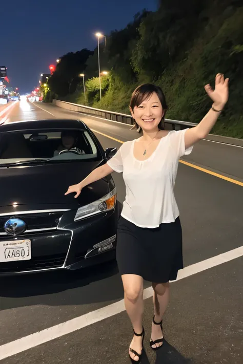 Car parts are scattered on the highway, and a black Prius is parked on the side of the road with its front end crashed. With this in the background, 44-years old Hirosue Ryoko is walking towards us.at night, She has her arms outstretched, posing like a cat...