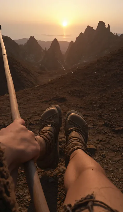 First-person view (POV) of the legs of a prehistoric warrior walking along a spiky mountaintop at sunset, holding a spear. Dressed in a rustic style with furs and ropes, the woman is centered in the image. The woman's legs, hands, and feet are visible from...