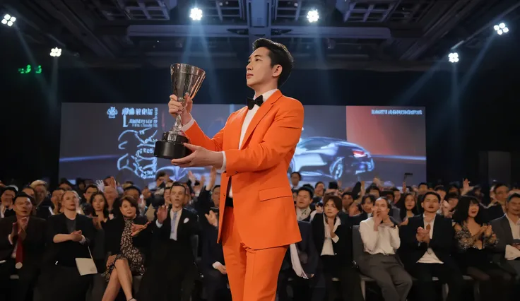 handsome Asian real estate agent wearing orange suit, standing on stage holding trophy, spotlight focused on him, audience clapping, luxury business event vibe, realistic photography style, 16:9