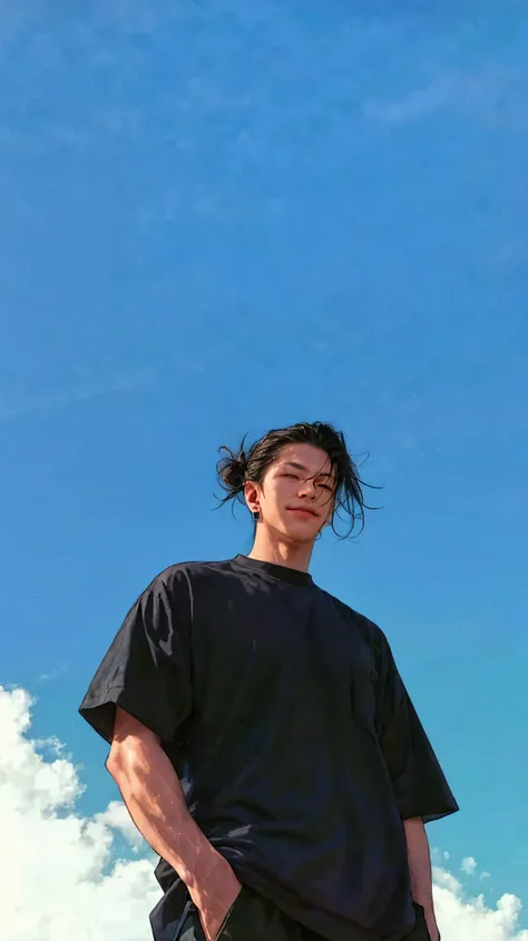 > A hyper-realistic cinematic photo of a confident young man seen from a low-angle perspective, standing outdoors under a bright, cloudless blue sky. He is wearing a loose black t-shirt and dark pants, with his hands in his pockets. His long black hair is ...