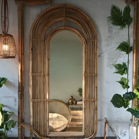 a close up of a mirror in a room with a plant